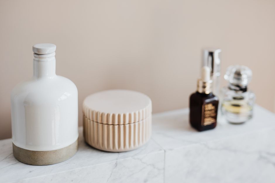Skincare devices and products on a modern bathroom shelf